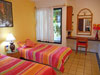 Guest bedroom has two twin beds and garden view.