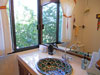 Master Bath with handpainted sink and garden view.