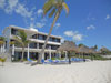 Yool Caanal's lovely white sand beach has lounge chairs and thatched palapas.