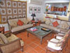 Living room has a festive decor, bar area, TV with DVD's and stereo for CD's and mp3. Glass doors open to a covered patio and terrace.