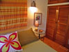 Master bedroom has king bed and garden view.