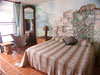 Glass doors opening to a covered balcony. Painted murals of Akumal Bay and Mayan ruins.